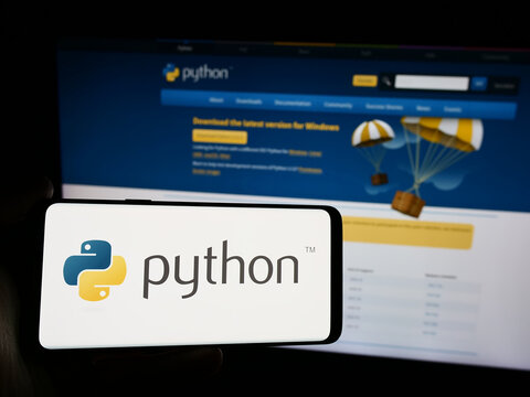 Stuttgart, Germany - 07-17-2024: Person holding smartphone with logo of organisation Python Software Foundation (PSF) in front of website. Focus on phone display.