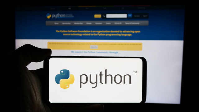 Stuttgart, Germany - 07-17-2024: Person holding cellphone with logo of organisation Python Software Foundation (PSF) in front of webpage. Focus on phone display.
