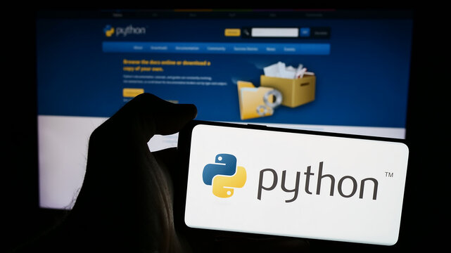 Stuttgart, Germany - 07-17-2024: Person holding mobile phone with logo of organisation Python Software Foundation (PSF) in front of web page. Focus on phone display.