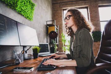 Photo of successful nice woman coder hacker sitting armchair comfortable workspace workstation...