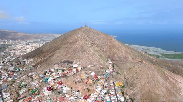 Aerial view of Galdar town city village under the mountain against seascape in Gran Canaria, Spain