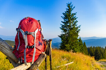 Hiking backpack with trekking poles for mountain hiking.