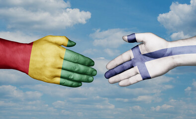 Finland and  Guinea-Conakry country handshaking with flags, consensus concept international co-operation illustration