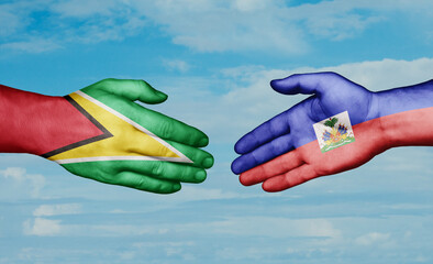 Haiti and Guyana country handshaking with flags, consensus concept international co-operation illustration
