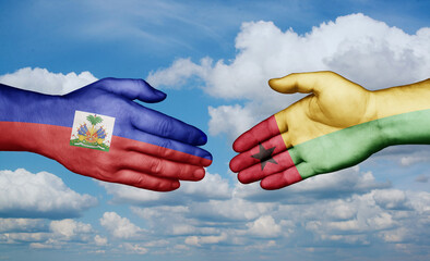 Guinea-Bissau and Haiti country handshaking with flags, consensus concept international co-operation illustration