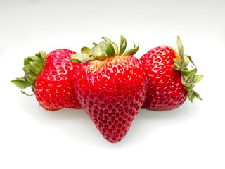 Ripe strawberries on white background.