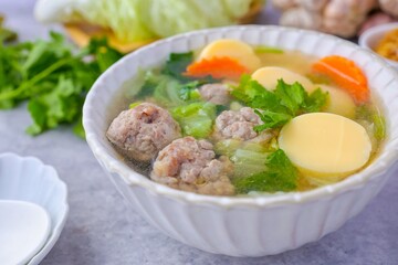 Home made Clear Soup with Bean Curd and Minced Pork and seaweed , top view food,Clear Soup with Egg Tofu ,vegetable and Minced Pork ball ,thai food,Thai call kang jued tao hoo moo sab