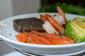Healthy seafood plate with salmon, shrimp and avocado. Low-carbohydrate breakfast rich in healthy fats. Concept of good nutrition and health. High quality photo