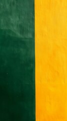 Fototapeta premium Vibrant textured green and yellow wall background with vintage charm, perfect for creative projects. Eye-catching two-tone design with space for text. Ideal for adding color to your project!