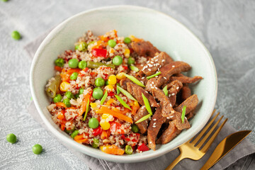 Stewed vegetables with quinoa and beef in a bowl on the table.