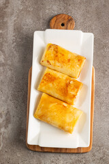 Thin pancakes stuffed with cottage cheese served with sour cream and black currant jam. French crepes. 