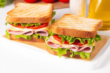 Club sandwich with ham, cheese, tomato and lettuce. 