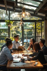 Fototapeta premium A group of people are sitting around a table in a conference room. They are all wearing business attire and are focused on their work. The atmosphere is professional and serious