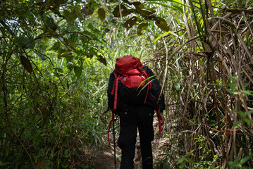 A man climbs a mountain alone