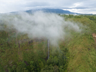 Aerial view of a waterfall covered in mist