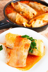 Cabbage Rolls With Filling on Plate and in Pan