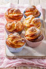 Rose-shaped yeast dough buns sprinkled with sugar in ceramic molds.