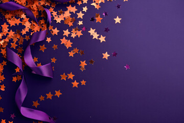 vibrant orange star confetti and purple ribbon curls on a deep  background
