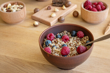 Healthy meal background, bowl with quinoa, berries and nuts