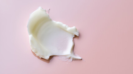 Texture of cosmetic butter on a pink background. Showcasing a thick and nourishing texture.