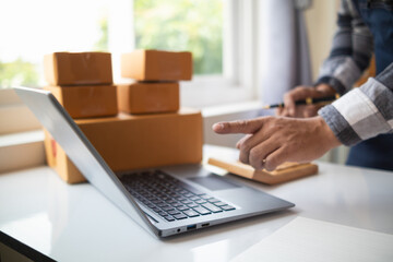 Fototapeta premium Start Up Business or small SME business owners open an office at home conduct online business and check product stock before sending products according orders customers who order products online.