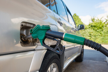 Close-up gas pump hose. Fueling a car with gasoline.