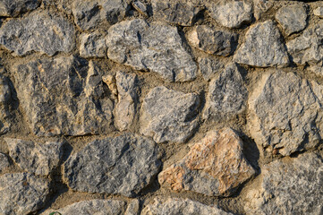grey stone dark wall of medieval horizontal stones facade background