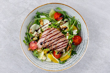 Peking duck on salad with orange on gray background for delivery restaurant menu