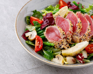 Tuna salad on a gray background. Nicoise salad, for restaurant menu for delivery