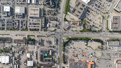 Aerial view of a commercial and industrial area with various buildings, parking lots, and roads