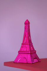 
Bright pink ceramic Eifel Tower with pink isolated background and copy space. Vertical image.