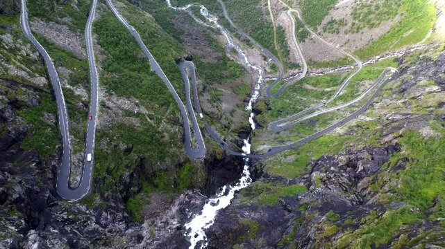 Explore the natural beauty of Norway with a trekking adventure through the Trollstigen route. A drone's view captures the stunning panorama of the famous places, winding through high mountains