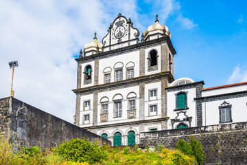 Fototapeta premium Square with small garden in front of traditional style old church in Horta town, Faial island, Azores, Portugal