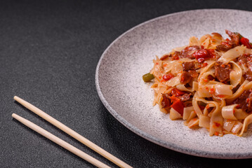 Delicious asian udon dish with vegetables, meat, salt and spices