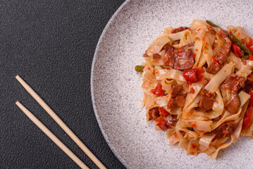 Delicious asian udon dish with vegetables, meat, salt and spices