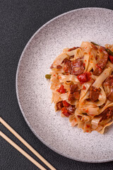 Delicious asian udon dish with vegetables, meat, salt and spices