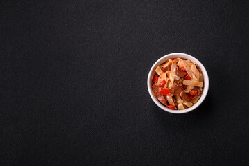 Delicious asian udon dish with vegetables, meat, salt and spices