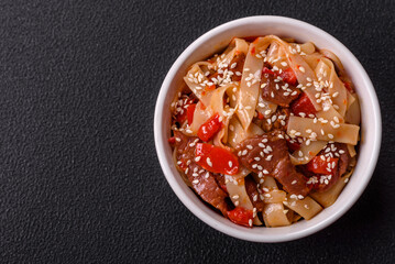 Delicious asian udon dish with vegetables, meat, salt and spices