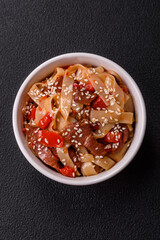 Delicious asian udon dish with vegetables, meat, salt and spices