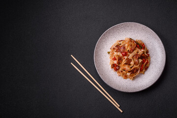 Delicious asian udon dish with vegetables, meat, salt and spices