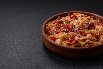 Delicious asian udon dish with vegetables, meat, salt and spices