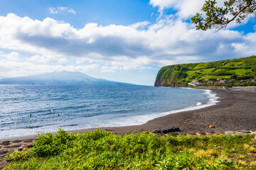 Almoxarife black sand volcanic beach with blue ocean on coast of Faial island, Azores, Portugal