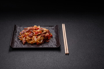 Delicious asian udon dish with vegetables, meat, salt and spices