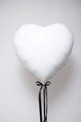 white heart foil balloon on white background