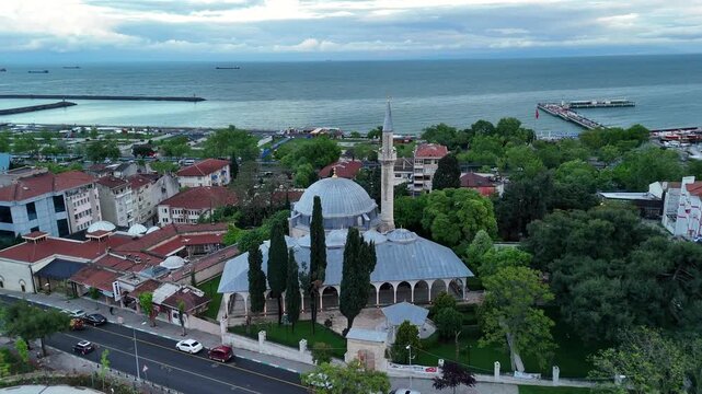 Aerial footage of the cityscape view of Tekirdag showing a mosque with buildings and a sea behind