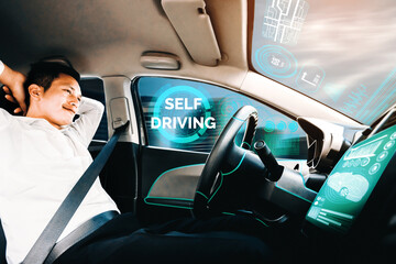 Self-driving autonomous car with relaxed young man sitting at driver seat is driving on busy highway road in the city. Concept of machine learning, artificial intelligence and augmented reality. uds