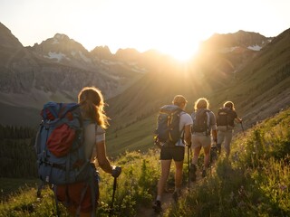 Mountain trekking adventure with a group of hikers exploring the trails. Men and women travel together, enjoying the summer sunset and the active experience of nature tourism.