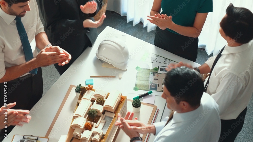 Aufkleber top view of team clapping hands to celebrate project at meeting table with house model, architectura