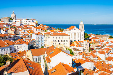 Fototapeta premium View of rooftops and skyline of Alfama district, the oldest neighborhood of Lisbon in Portugal