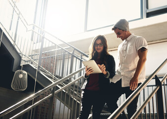 Employees, tablet and stairs for talking for design plan, graphic designers and app for creativity....